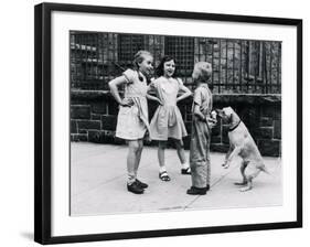 Dog Eating Ice Cream Cone Hidden behind Boy's Back-William Milnarik-Framed Photographic Print