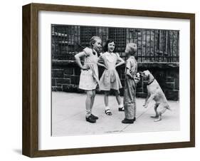 Dog Eating Ice Cream Cone Hidden behind Boy's Back-William Milnarik-Framed Photographic Print