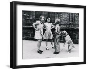 Dog Eating Ice Cream Cone Hidden behind Boy's Back-William Milnarik-Framed Photographic Print