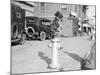 Dog Seated on Fire Hydrant-Bettmann-Mounted Photographic Print