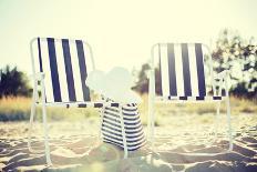 Furniture and Summer Holidays Concept - Two Beach Lounges with Beach Bag and White Hat on the Beach-dolgachov-Photographic Print