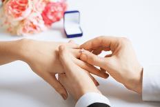 Picture of Man Putting Wedding Ring on Woman Hand-dolgachov-Framed Photographic Print