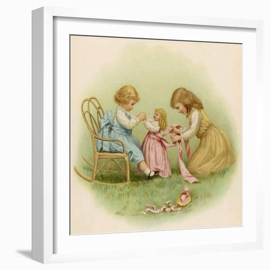 Doll is Dressed by Two Girls One in Front of Her While the Other Ties Her Sash Behind-Ida Waugh-Framed Photographic Print