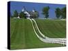 Double White Fence Flows from an Elegant Horse Barn, Woodford County, Kentucky, USA-Dennis Flaherty-Stretched Canvas