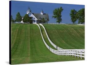 Double White Fence Flows from an Elegant Horse Barn, Woodford County, Kentucky, USA-Dennis Flaherty-Stretched Canvas