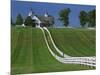 Double White Fence Flows from an Elegant Horse Barn, Woodford County, Kentucky, USA-Dennis Flaherty-Mounted Photographic Print