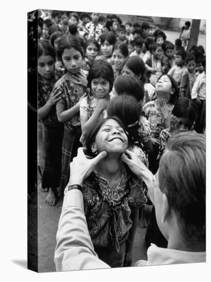 Dr. Nevin S. Scrimshaw of the Central American Institute of Nutrition Examining Children for Goiter-Cornell Capa-Stretched Canvas