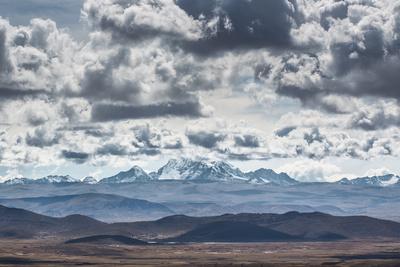 https://imgc.allpostersimages.com/img/posters/dramatic-clouds-billow-above-a-landscape-with-the-cordillera-real-in-the-distance_u-L-POLBFI0.jpg?artPerspective=n