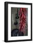 Dried Chillipods Hang Infront of Wooden Wall with Culinary Utensils-Jana Ihle-Framed Photographic Print