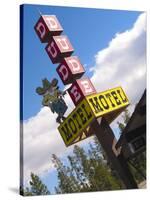 Dude Motel Sign, West Yellowstone, Montana, USA-Nancy & Steve Ross-Stretched Canvas