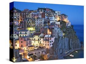 Dusk Falls on a Hillside Town Overlooking the Mediterranean Sea, Manarola, Cinque Terre, Italy-Dennis Flaherty-Stretched Canvas