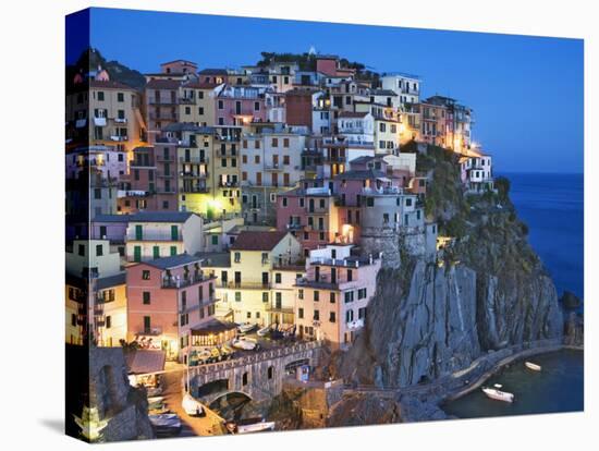 Dusk Falls on a Hillside Town Overlooking the Mediterranean Sea, Manarola, Cinque Terre, Italy-Dennis Flaherty-Stretched Canvas