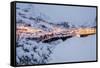 Dusk lights on the fishing village surrounded by snowy peaks, Nusfjord, Northern Norway-Roberto Moiola-Framed Stretched Canvas