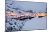 Dusk lights on the fishing village surrounded by snowy peaks, Nusfjord, Northern Norway-Roberto Moiola-Mounted Photographic Print