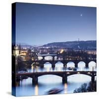 Dusk lights up the historical bridges and buildings reflected on Vltava River, Prague, Czech Republ-Roberto Moiola-Stretched Canvas
