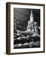 Dust Covered Wine and Brandy Bottles Lying on Racks in a Wine Cellar-Nina Leen-Framed Photographic Print