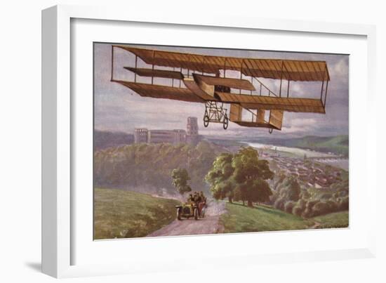 Early Biplane Flying Above a Car on a Country Road-null-Framed Giclee Print