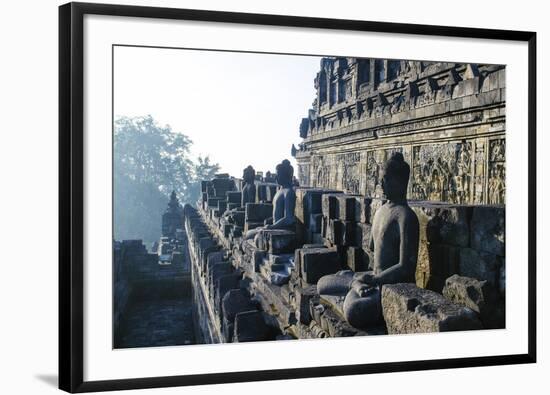 Early Morning Light Shining on Buddhas Sitting in the Temple Complex of Borobodur, Java, Indonesia-Michael Runkel-Framed Photographic Print