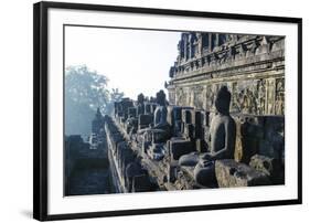 Early Morning Light Shining on Buddhas Sitting in the Temple Complex of Borobodur, Java, Indonesia-Michael Runkel-Framed Photographic Print