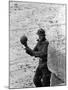 East German Border Guard Tossing Ball over Berlin Wall after German boy accidently threw it over-Paul Schutzer-Mounted Photographic Print