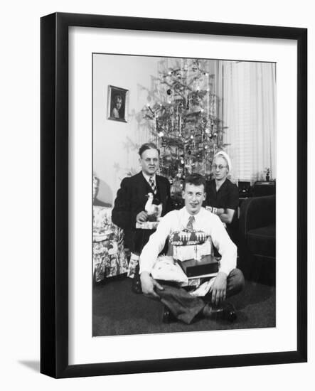 Eighteen Year Old Man with His Presents at Christmas, Ca. 1945-null-Framed Photographic Print