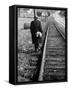 Elderly Hobo, with Bundle Strapped to His Back, Walking Along Train Tracks-Carl Mydans-Framed Stretched Canvas