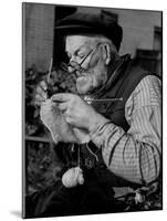 Elderly Man Knitting Garments During Drive to Provide Goods to Servicemen During the War-null-Mounted Photographic Print