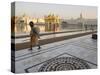 Elderly Sikh Pilgrim with Bundle and Stick Walking Around Holy Pool, Amritsar, India-Eitan Simanor-Stretched Canvas