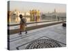 Elderly Sikh Pilgrim with Bundle and Stick Walking Around Holy Pool, Amritsar, India-Eitan Simanor-Stretched Canvas