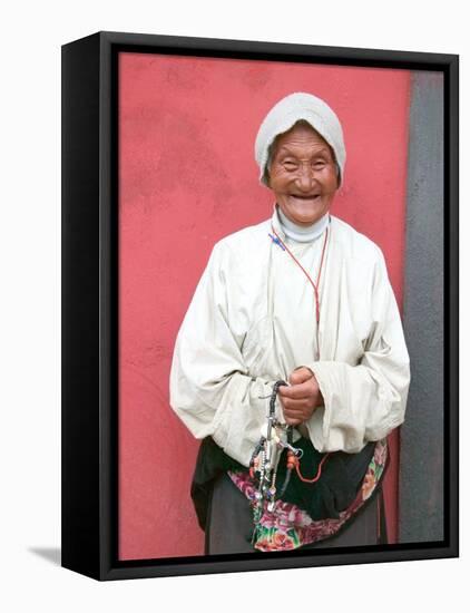 Elderly Tibetan Woman with Red Wall, Tagong, Sichuan, China-Keren Su-Framed Stretched Canvas