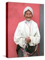 Elderly Tibetan Woman with Red Wall, Tagong, Sichuan, China-Keren Su-Stretched Canvas