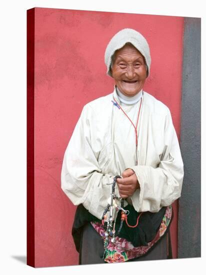 Elderly Tibetan Woman with Red Wall, Tagong, Sichuan, China-Keren Su-Stretched Canvas