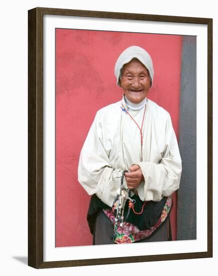 Elderly Tibetan Woman with Red Wall, Tagong, Sichuan, China-Keren Su-Framed Premium Photographic Print