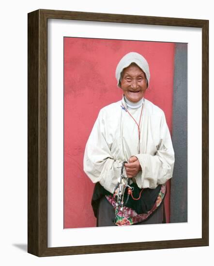 Elderly Tibetan Woman with Red Wall, Tagong, Sichuan, China-Keren Su-Framed Photographic Print