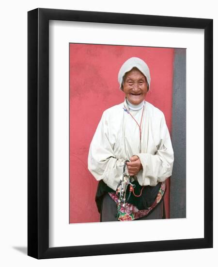 Elderly Tibetan Woman with Red Wall, Tagong, Sichuan, China-Keren Su-Framed Photographic Print