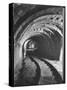 Electric Locomotive on Track in Powderly Anthracite Coal Mine Gangway, Owned by Hudson Coal Co-Margaret Bourke-White-Stretched Canvas