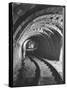 Electric Locomotive on Track in Powderly Anthracite Coal Mine Gangway, Owned by Hudson Coal Co-Margaret Bourke-White-Stretched Canvas