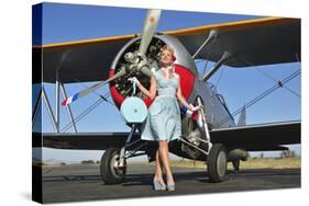 Elegant 1940's Style Pin-Up Girl Standing in Front of an F3F Biplane-null-Stretched Canvas