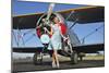 Elegant 1940's Style Pin-Up Girl Standing in Front of an F3F Biplane-null-Mounted Premium Photographic Print