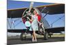 Elegant 1940's Style Pin-Up Girl Standing in Front of an F3F Biplane-null-Mounted Photographic Print
