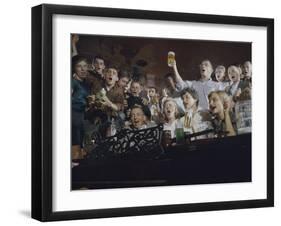 Elevated View of a Group of People as They Sing Along with a Pianist in a Unidentified Bar, 1959-Yale Joel-Framed Photographic Print