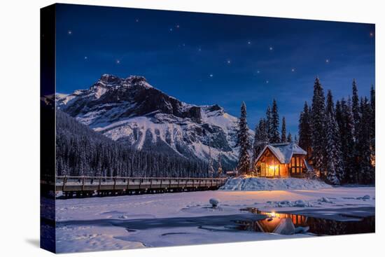 Emerald Lake Lodge in Banff, Canada during winter with snow and mountains at night with starry sky-David Chang-Stretched Canvas