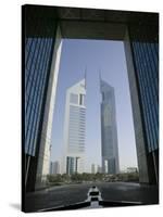 Emirates Towers Through Dubai International Financial Center Arch, Sheikh Zayed Road, Dubai, UAE-Walter Bibikow-Stretched Canvas