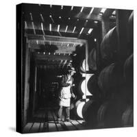 Employee in Warehouse of Jack Daniels Distillery Checking For Leaks in the Barrels-Ed Clark-Stretched Canvas