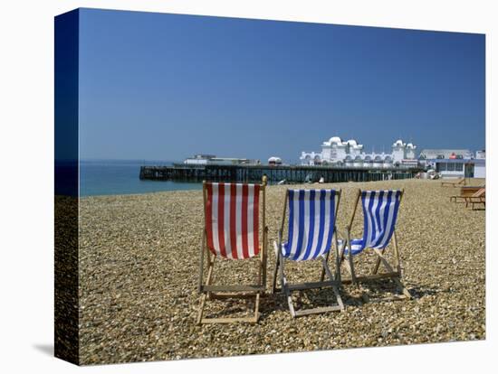 Empty Deck Chairs on the Beach and the Southsea Pier, Southsea, Hampshire, England, United Kingdom-Nigel Francis-Stretched Canvas