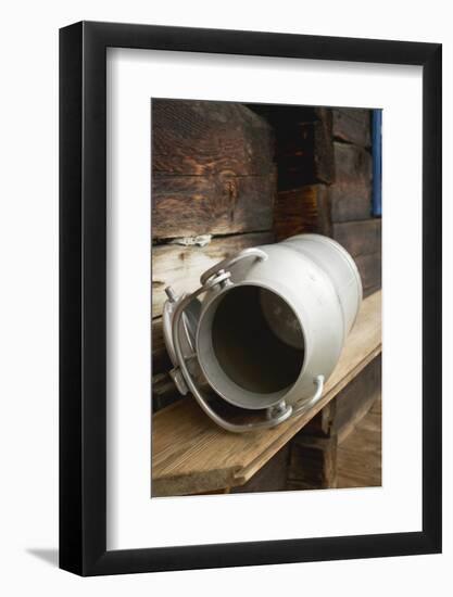 Empty Milk Can on Wooden Bench in Front of Alpine Chalet-Eising Studio - Food Photo and Video-Framed Photographic Print