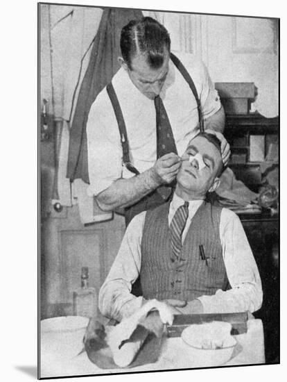 England Captain Eddie Hapgood Receives Treatment for a Broken Nose after a Match with Italy, 1934-null-Mounted Giclee Print