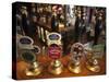 England, London, Beer Pump Handles at the Bar Inside Tradional Pub-Steve Vidler-Stretched Canvas