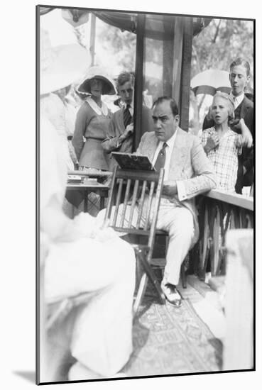 Enrico Caruso Leans Back on Chair Holding a Board with Music-null-Mounted Art Print