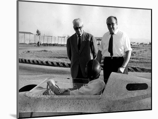 Enzo Ferrari, Carlo Chiti and Martino Severi Testing a New Racing Car-null-Mounted Photographic Print